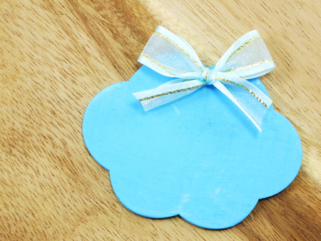 blue blank label tag on wooden backgroundの写真素材