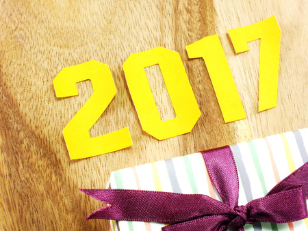 vintage happy new year background happy new year lettering with the gift on wooden backgroundの写真素材