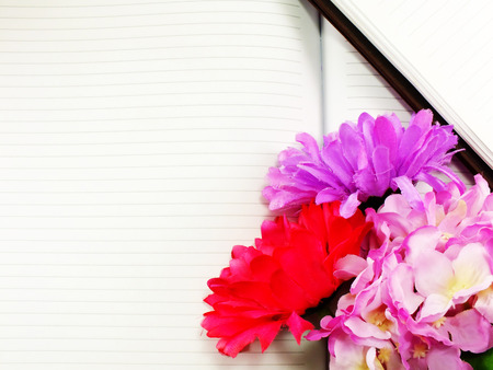 note book diary and beautiful flower bouquet backgroundの写真素材