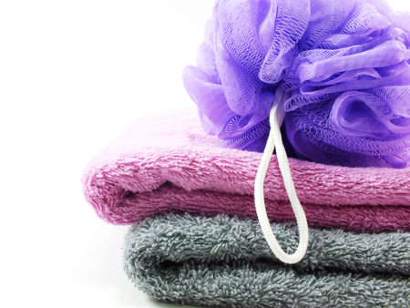 plastic bath puff and towel on white backgroundの写真素材