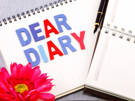 dear diary word on white paper notebook concept backgroundの写真素材