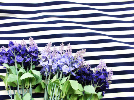 arrangement of artificial lavender flowers bouquet located on Blue and white stripesの写真素材