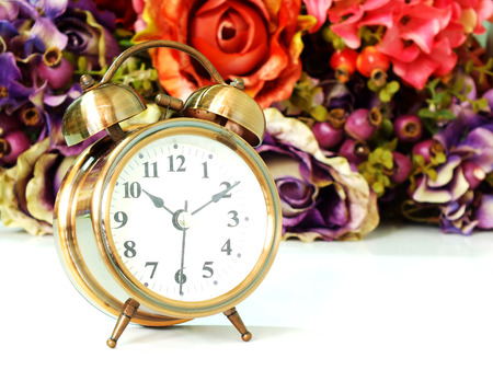 alarm clock with rose vintage flower background soft focusの写真素材