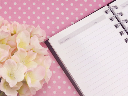 blank sheet of notebook and red and beautiful hydrangea of artificial flowersの写真素材