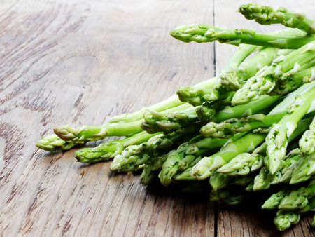 green raw asparagus on wooden table backgroundの写真素材