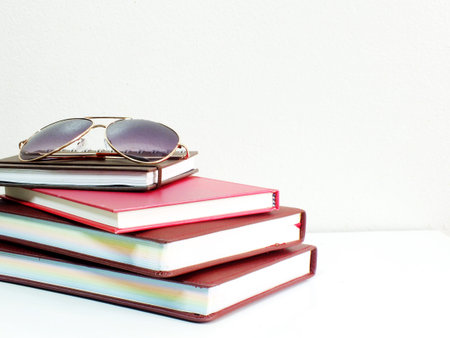 notebooks and sunglasses with copy space background