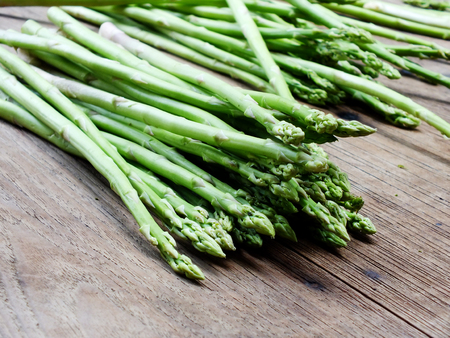 green fresh asparagus on wooden backgroundの写真素材