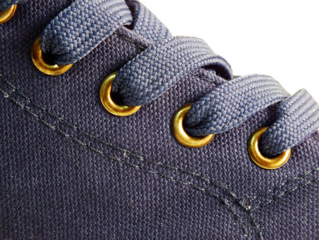 detail of a pair of blue canvas sneakers