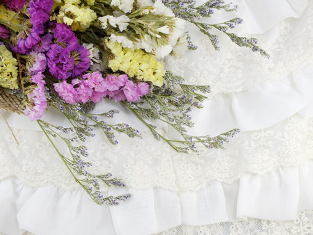 beautiful statice flowers bouquet with texture of fabricの写真素材