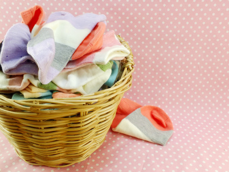 multi colored socks and laundry basketの写真素材