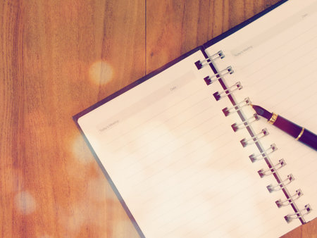 open notebook on a wooden table with vintage filter color