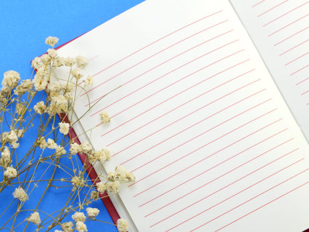 dried flowers and empty notebook page