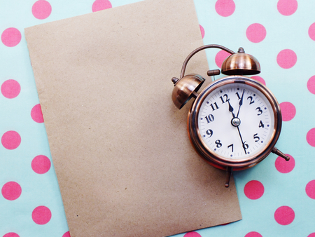 alarm clock on blue and pink polka dot backgroundの写真素材