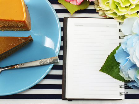 cake homemade on dish with spring flower and space copy backgroundの写真素材