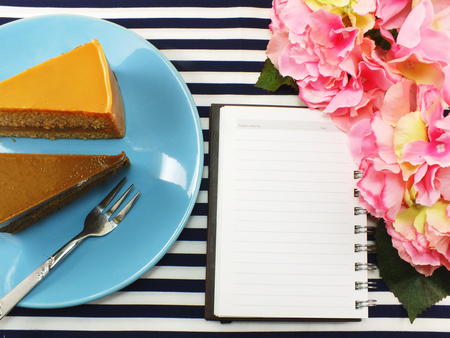 cake homemade on dish with spring flower and space copy backgroundの写真素材