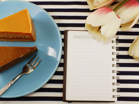 cake homemade on dish with spring flower and space copy backgroundの写真素材