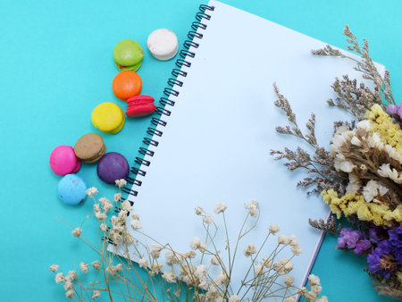 top view of macaroons flowers with diary copy space backgroundの写真素材