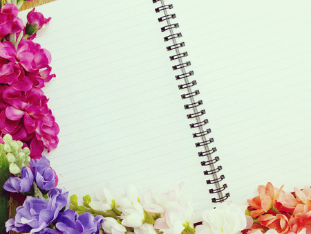 notebook pencil and flowers background  made with filters colorの写真素材