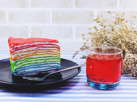 rainbow cake slice with chocolate sauceの写真素材