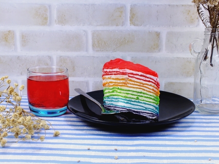 rainbow cake slice with chocolate sauceの写真素材