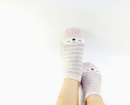 close up of the bare legs of a young ladies wearing socksの写真素材