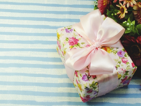 beautiful romantic gift box and flower on blue background beautiful romantic gift box and flower on blue backgroundの写真素材