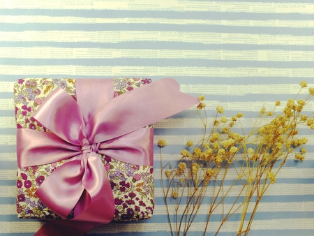 beautiful romantic gift box and flower on blue backgroundの写真素材