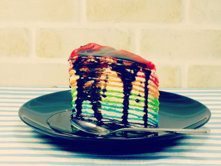 rainbow cake slice with chocolate sauce
