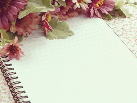 open notebook with cup of coffee on wooden deskの写真素材