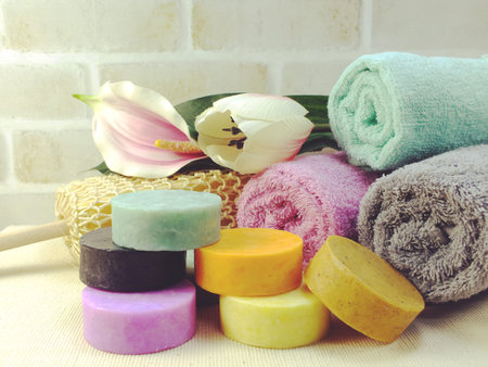 fruit soap and colorful bath towels spa and healthy backgroundの写真素材