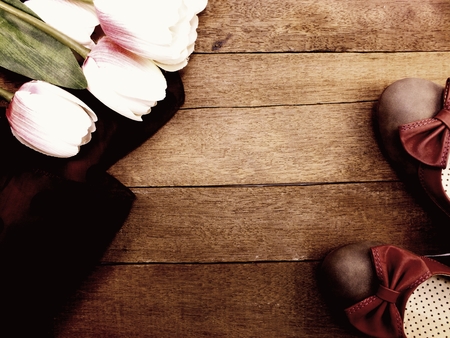 woman flats shoes and flower bouquet on wooden backgroundの写真素材