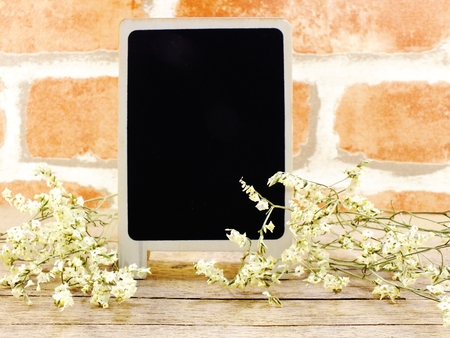 mock up black wooden background with flowers blossom decorationsの写真素材