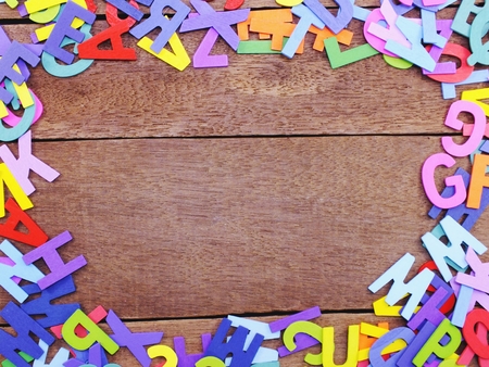 colorful alphabet letters on wooden background concepの写真素材