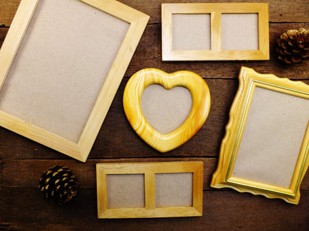blank photo frames on the table wooden background