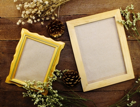 blank photo frames on the table wooden backgroundの写真素材
