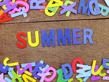 colorful wooden alphabet summer spelling on wooden backgroundの写真素材