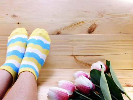 close up of woman s feet in multi color socks with space background