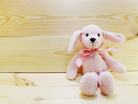cute rabbit doll on wooden background and space copyの写真素材
