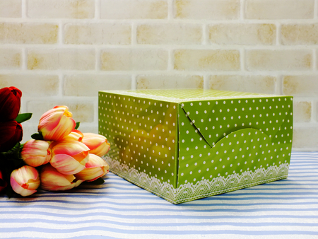green polka dot gift box with flowers bouquetの写真素材