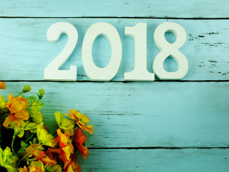 number wooden new year on blank paper notebook on wooden background