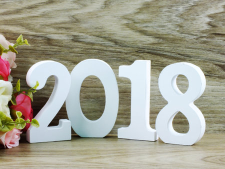 number wooden new year on blank paper notebook on wooden background