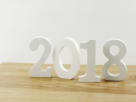 number wooden new year on blank paper notebook on wooden backgroundの写真素材