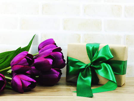 gift box whit green bow ribbon on wooden backgroundの写真素材