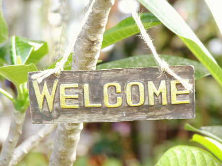 welcome sign hanging in the gardenの写真素材
