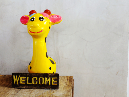cute giraffe statue ceramic with space copy on wooden backgroundの写真素材