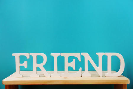 friend word decorative letters on wooden backgroundの写真素材