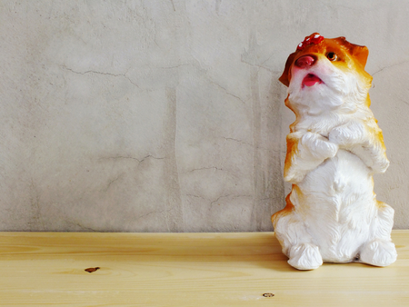 dog statue ceramic with space copy on wooden backgroundの写真素材