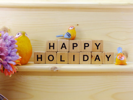 home decoration with text happy holidays on wooden background