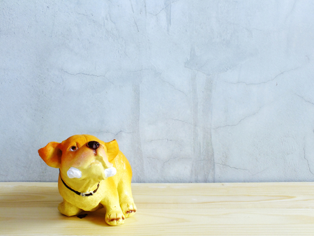 dog statue ceramic with space copy on wooden backgroundの写真素材
