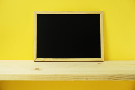 wooden frame chalk board on wooden backgroundの写真素材